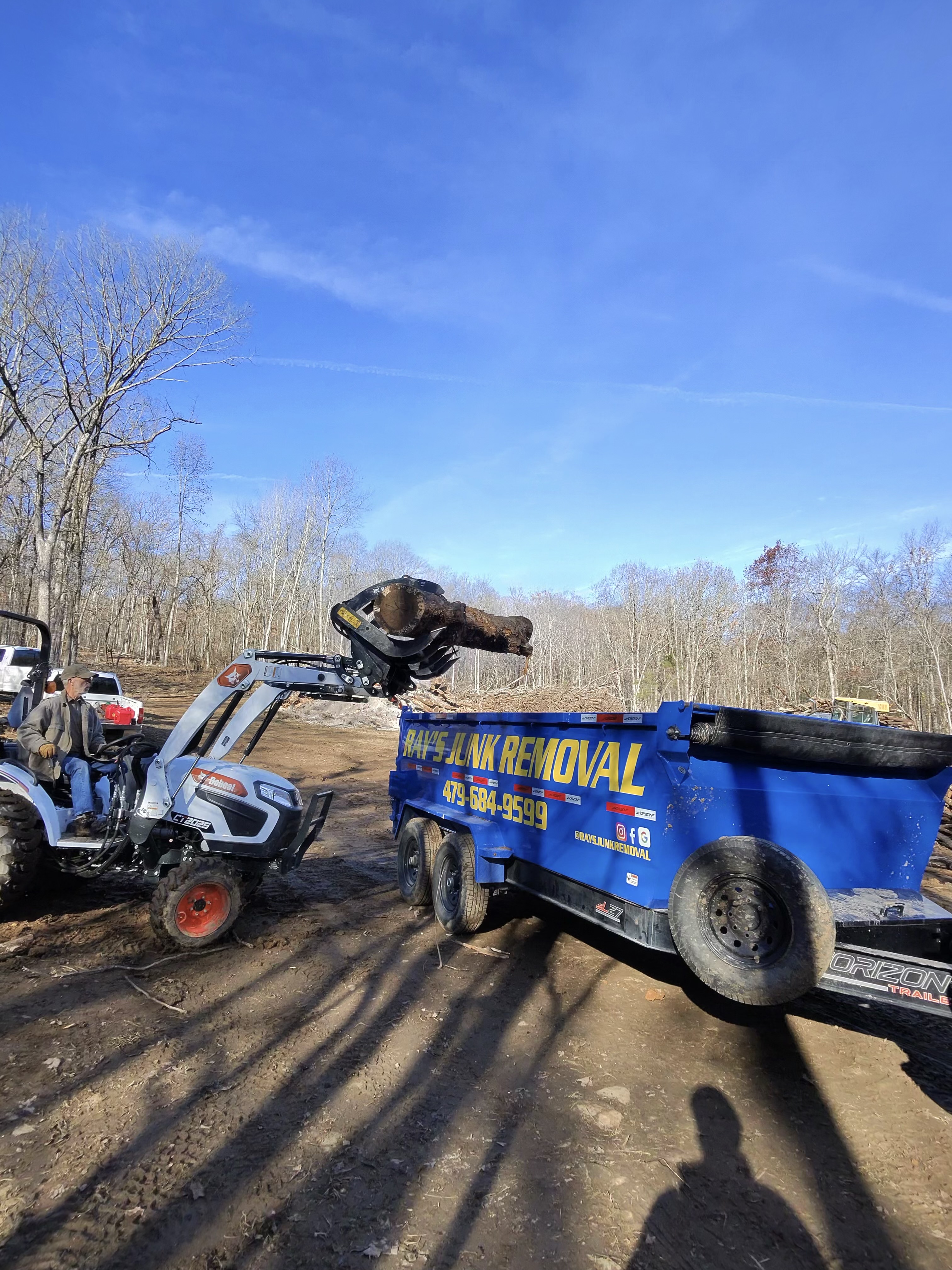 Loading Tree into Dump Pickup Using Machine